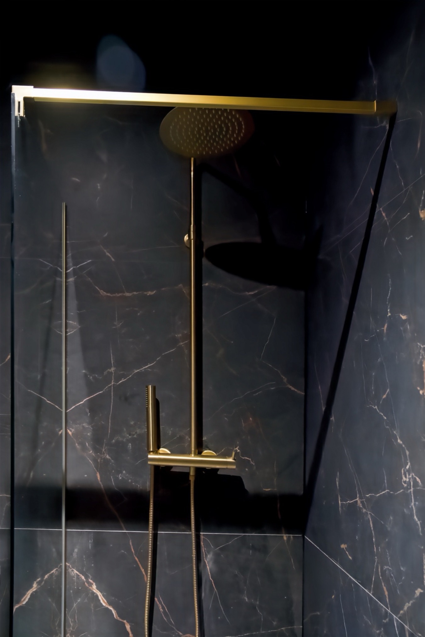 Gold walk-in rain shower and black marble in the Ciné Room